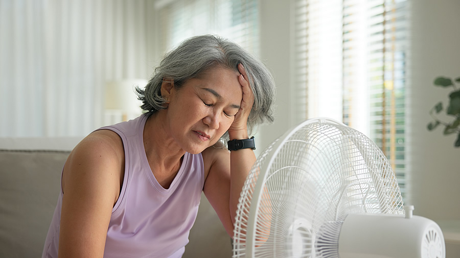 Woman Feeling Ill Sitting in Front of Fan.jpg